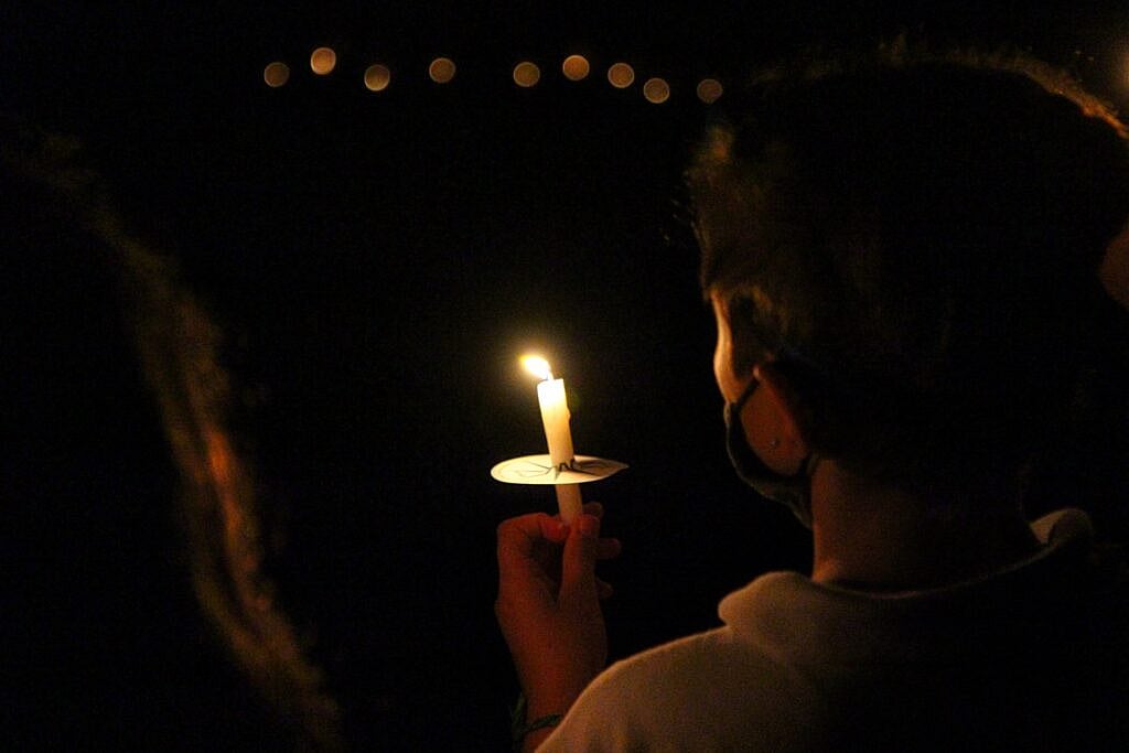 camp girl holding ceremonial candle
