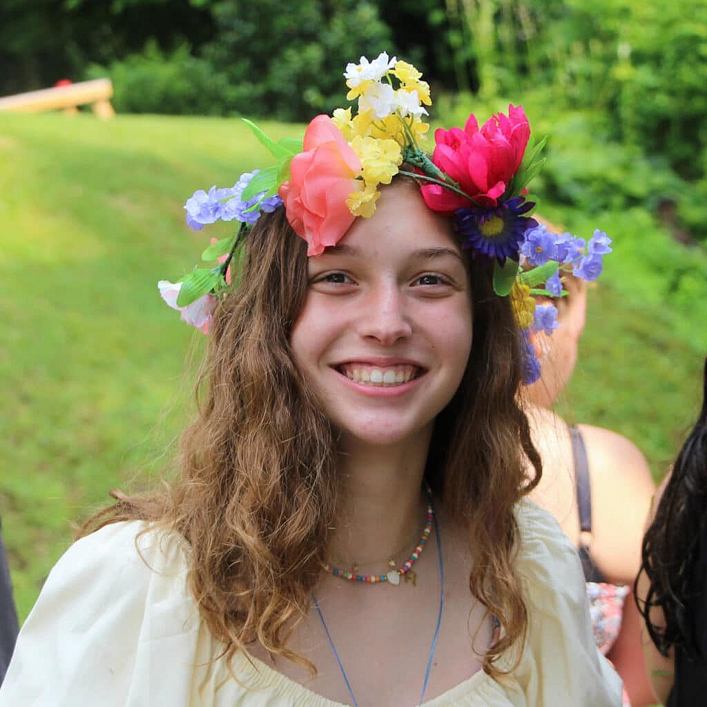 teenager wearing flower crown at camp