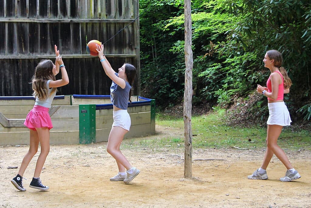 summer camp girls playing tetherball