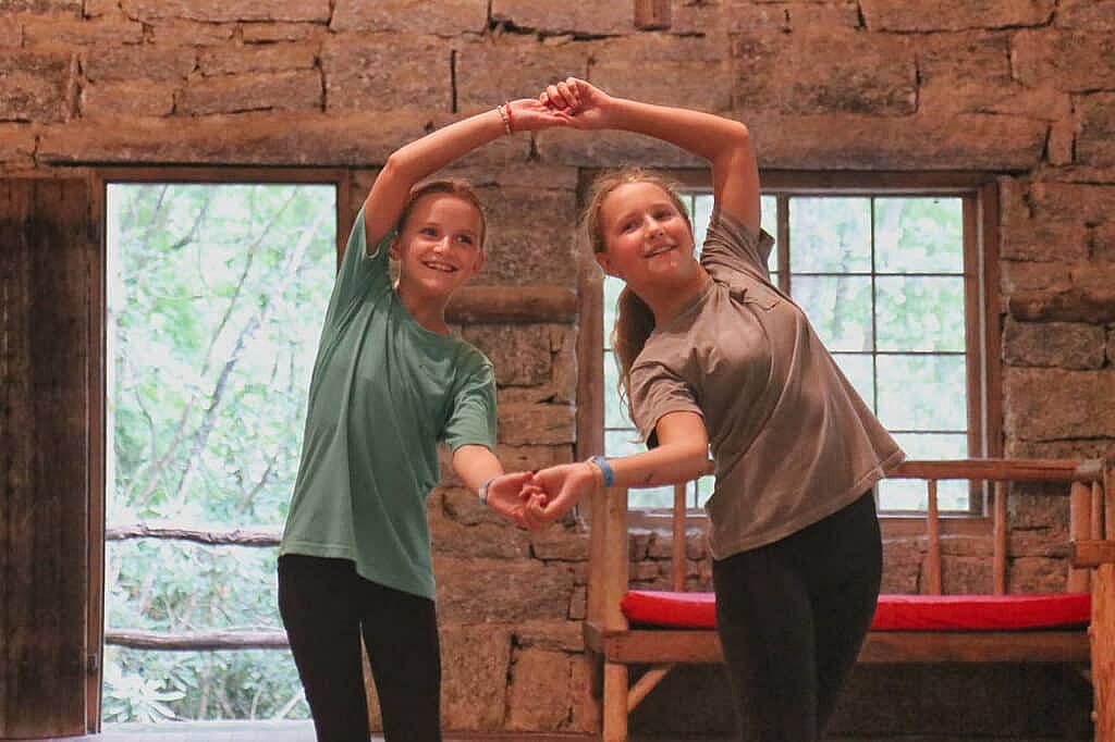 a duo of camp girls dancing