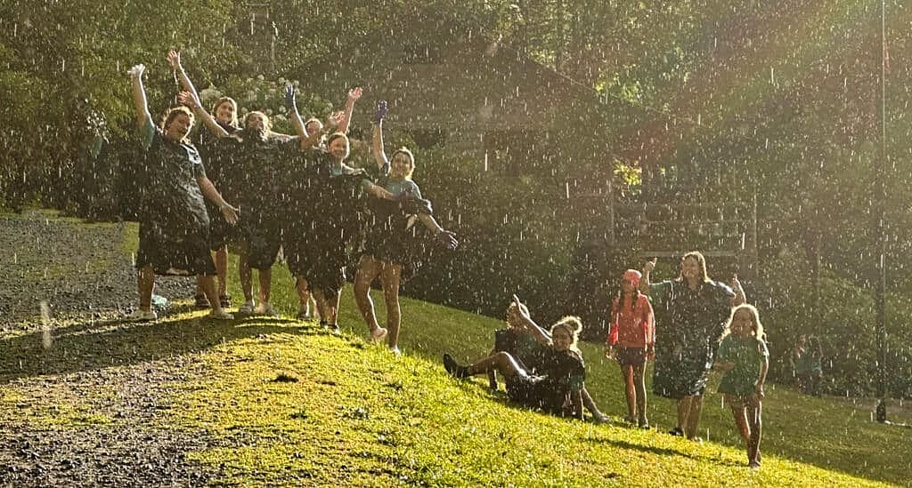 campers dancing in the rain