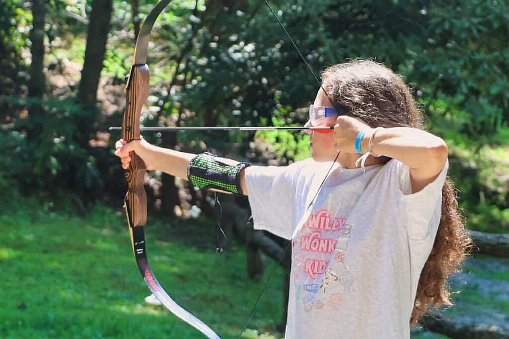 girl archer at summer camp