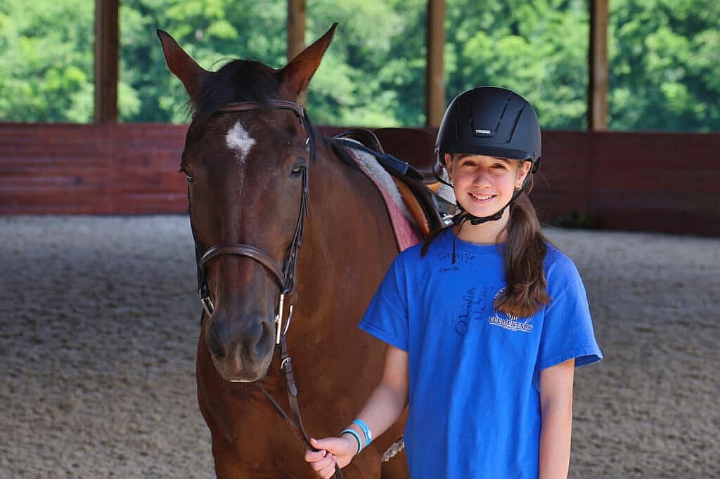 girls standing with horse