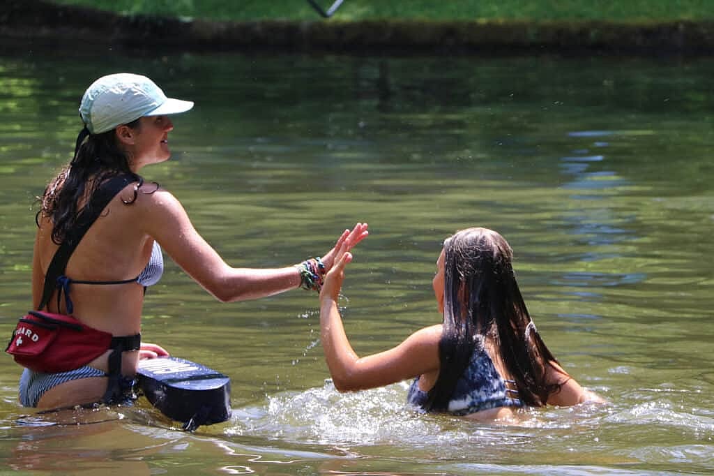 swimming high five with lifeguard