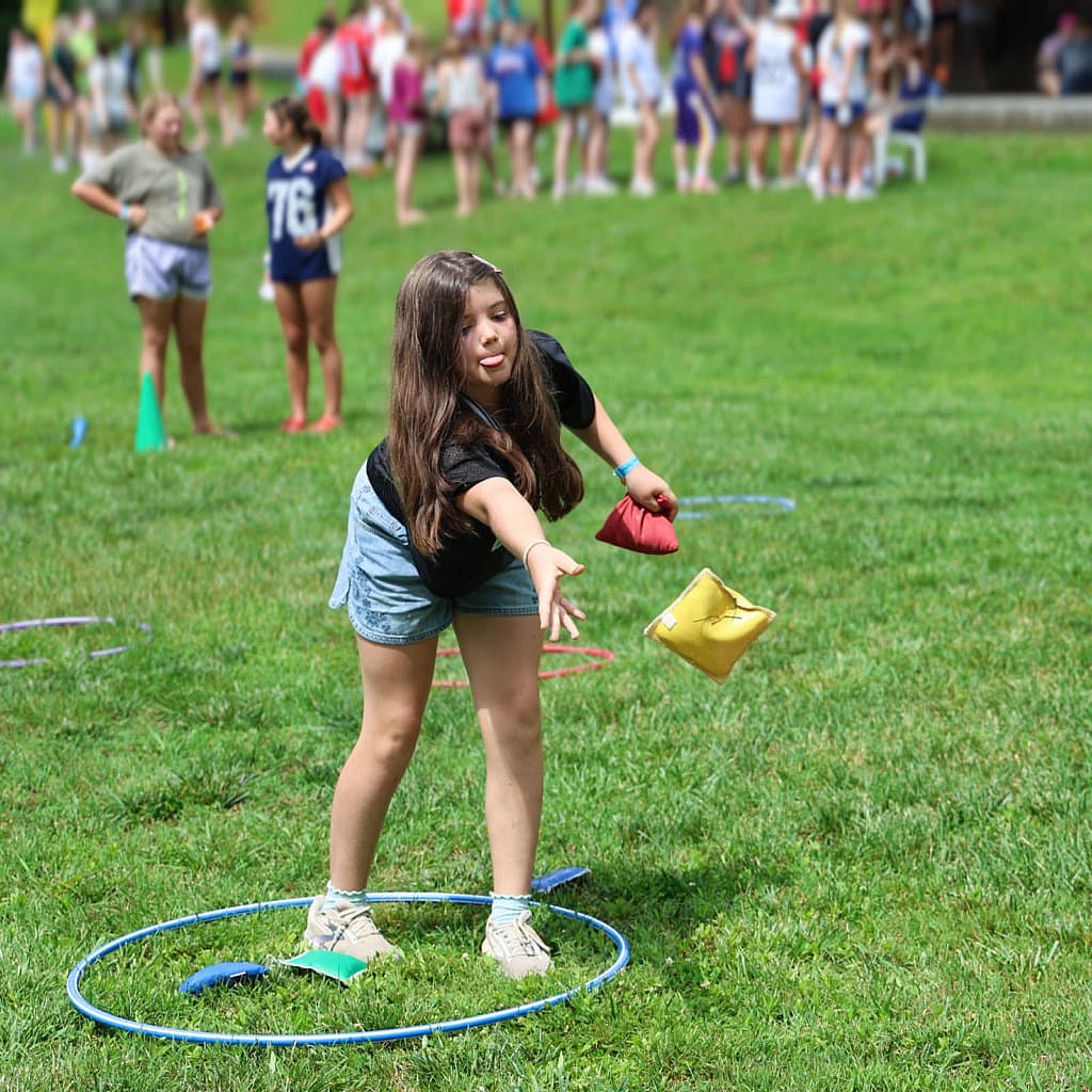 camper tossing bean bag