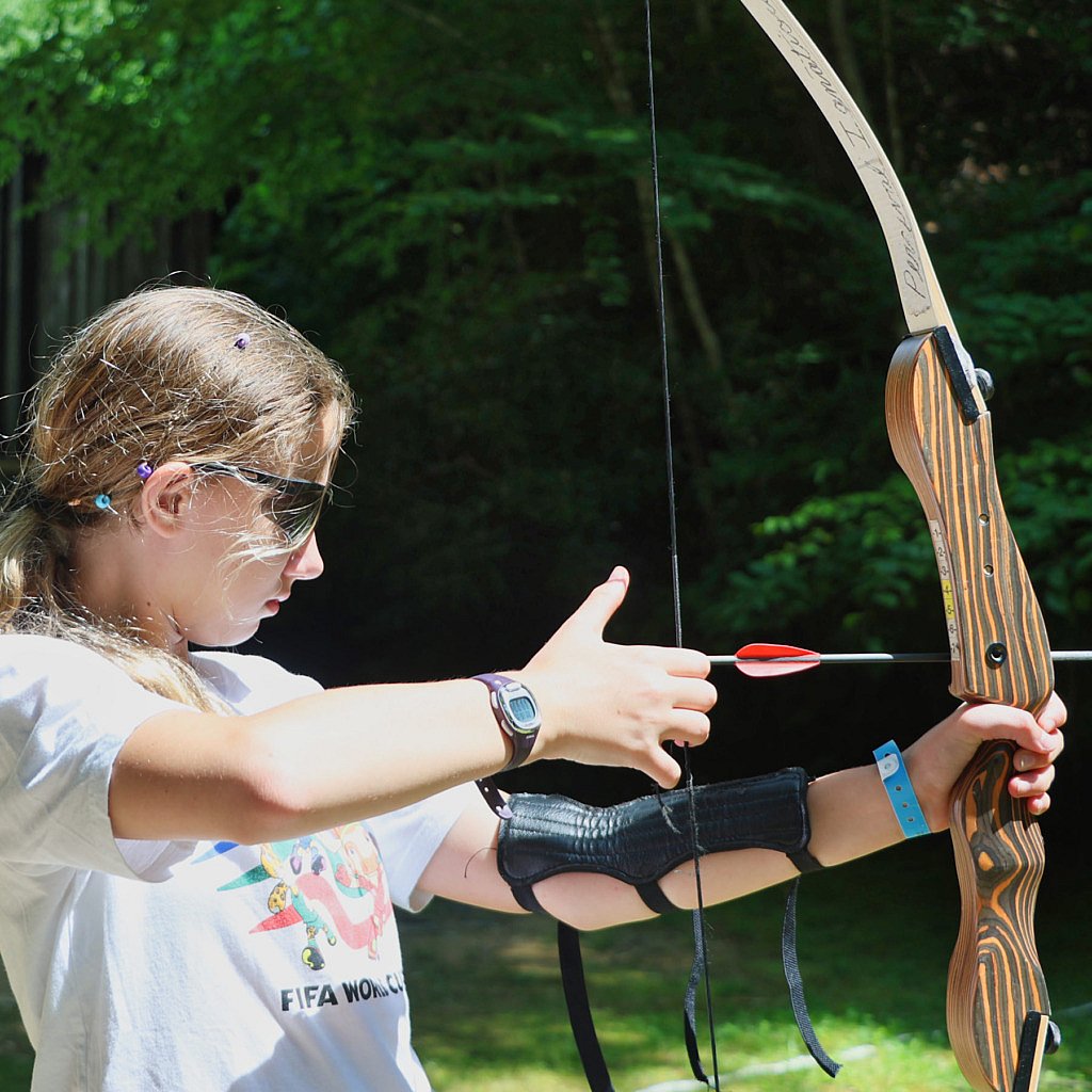focused girl shooting archery