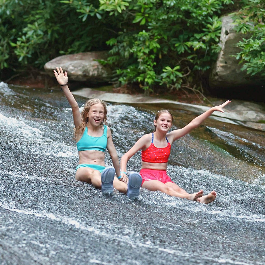 camp girls zooming down sliding rock