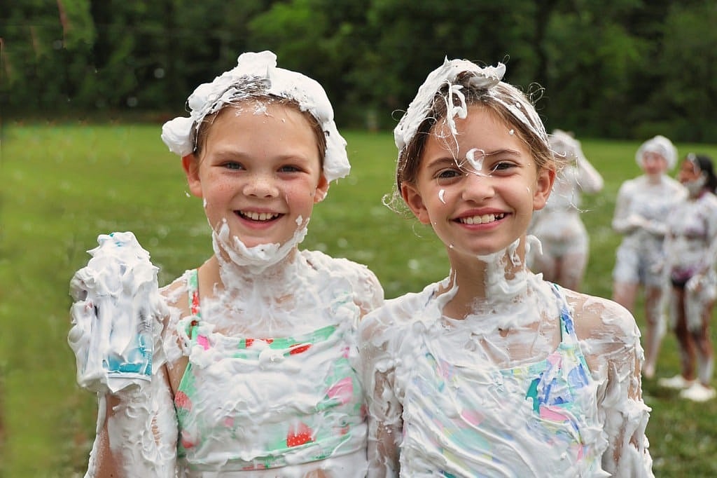 two camp girls covered in shaving cream