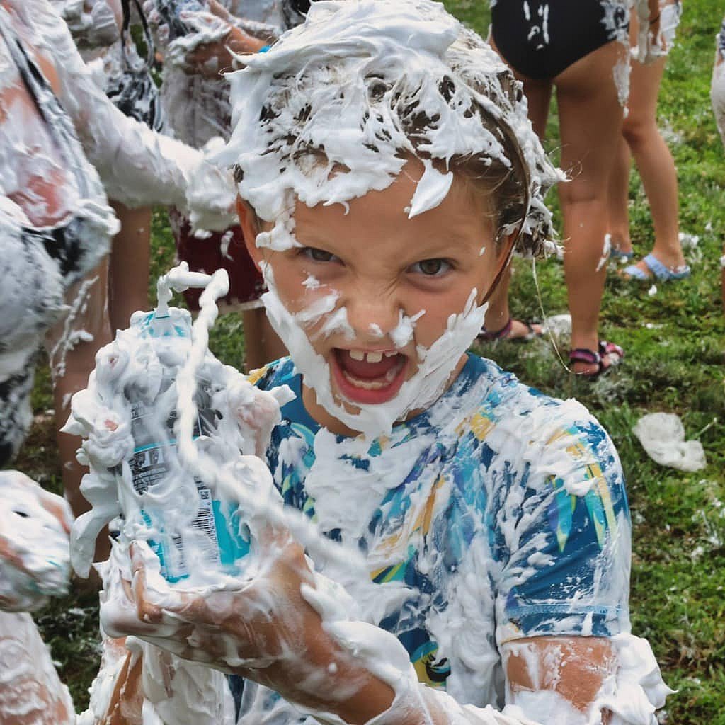 small girl ready to attack with shaving cream