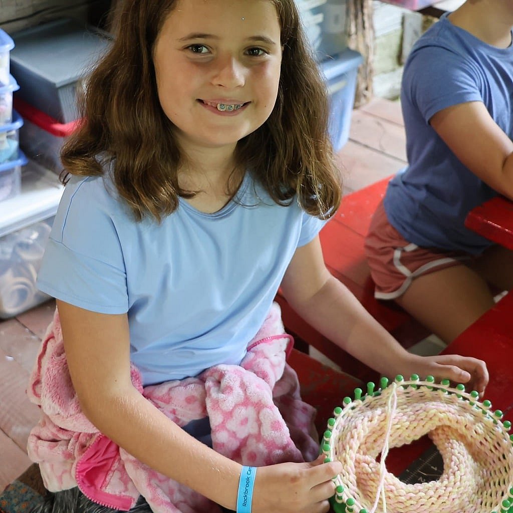 camp girl knitting on ring