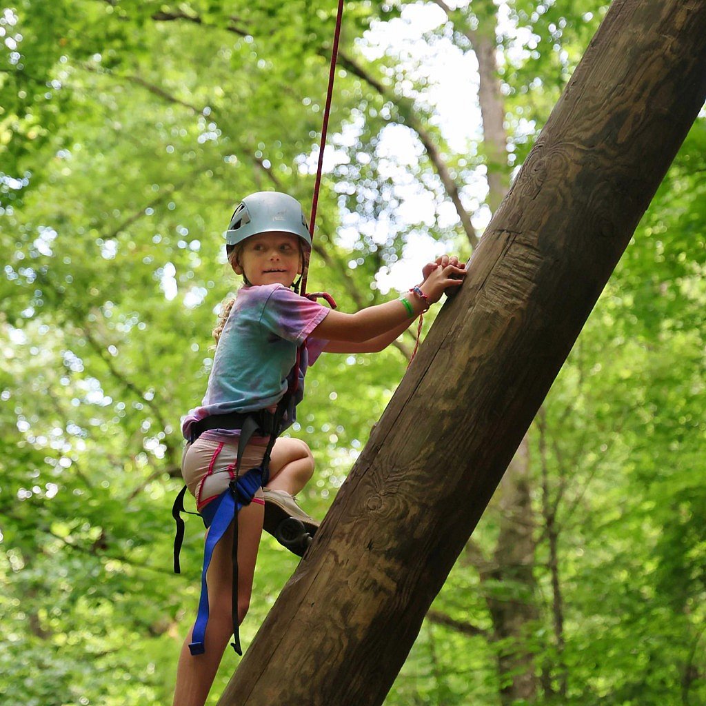 youn summer camp girl climbing