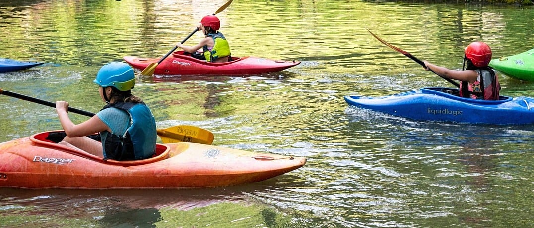 camp kids enjoying a kayaking adventure