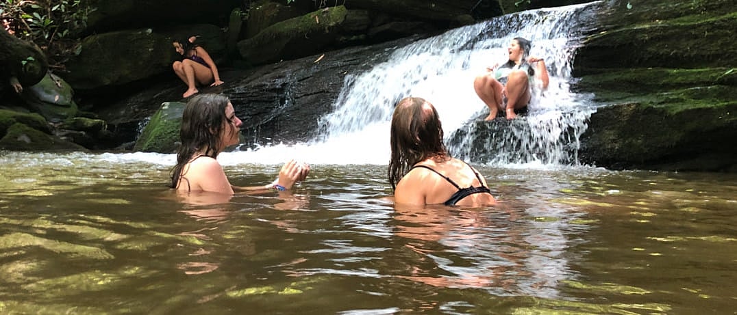 summer camp girls swimming in creek