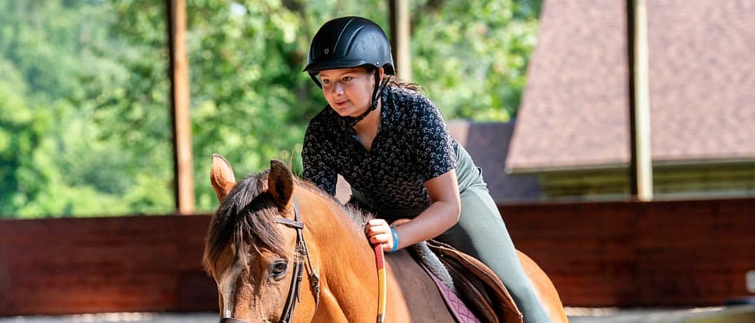 focused girl riding horse