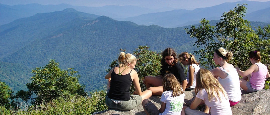 camp girls hiking to mountain for big view