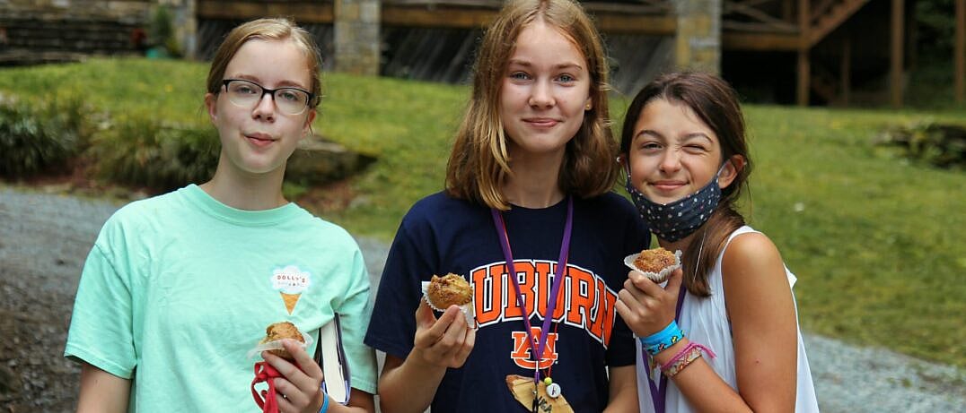 camp girls eating fresh muffins