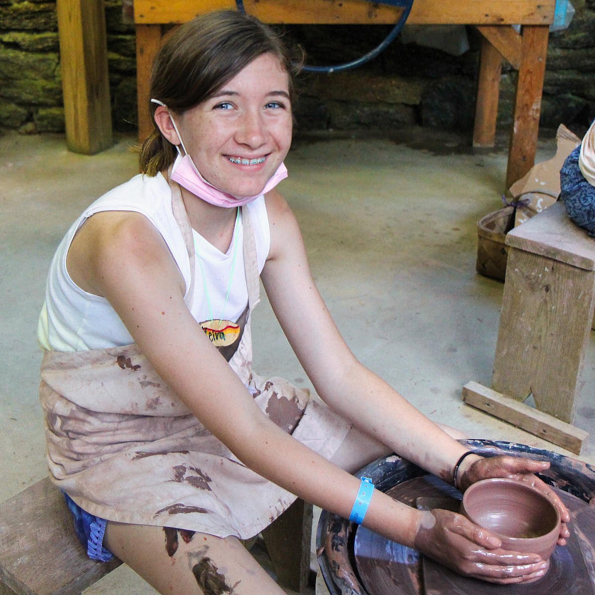 pottery kid proud of her work