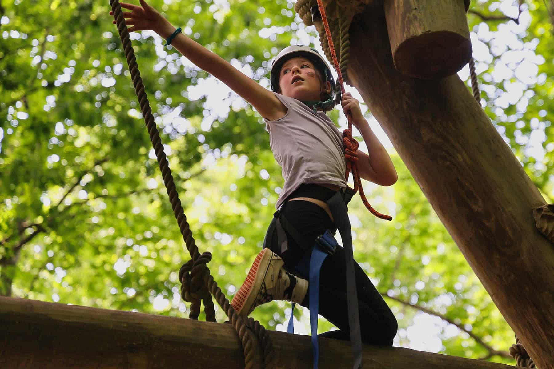 camp girl climbing tower