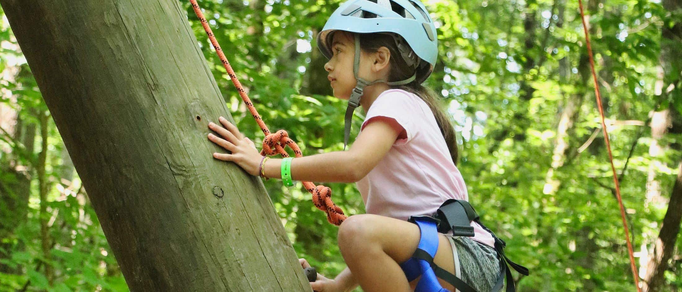 camp girl climbing tower