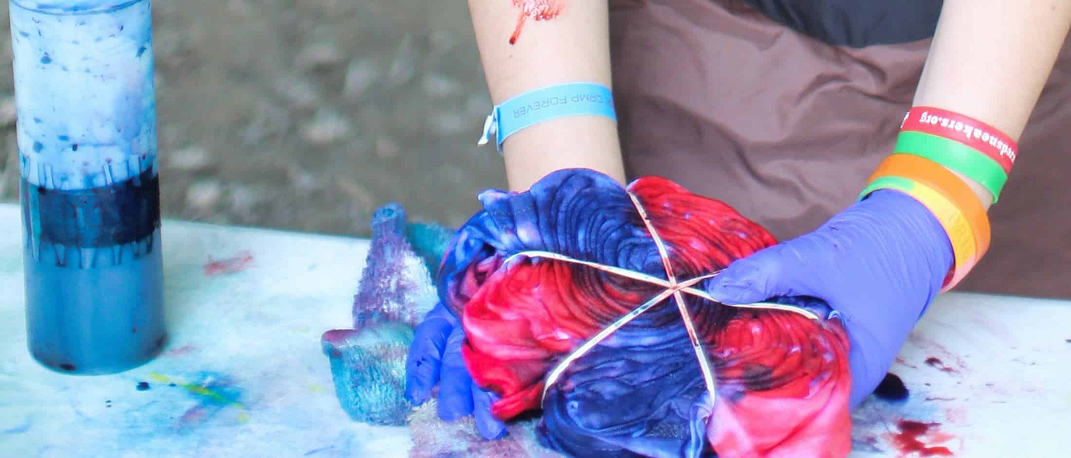 camp girl tie dye hands