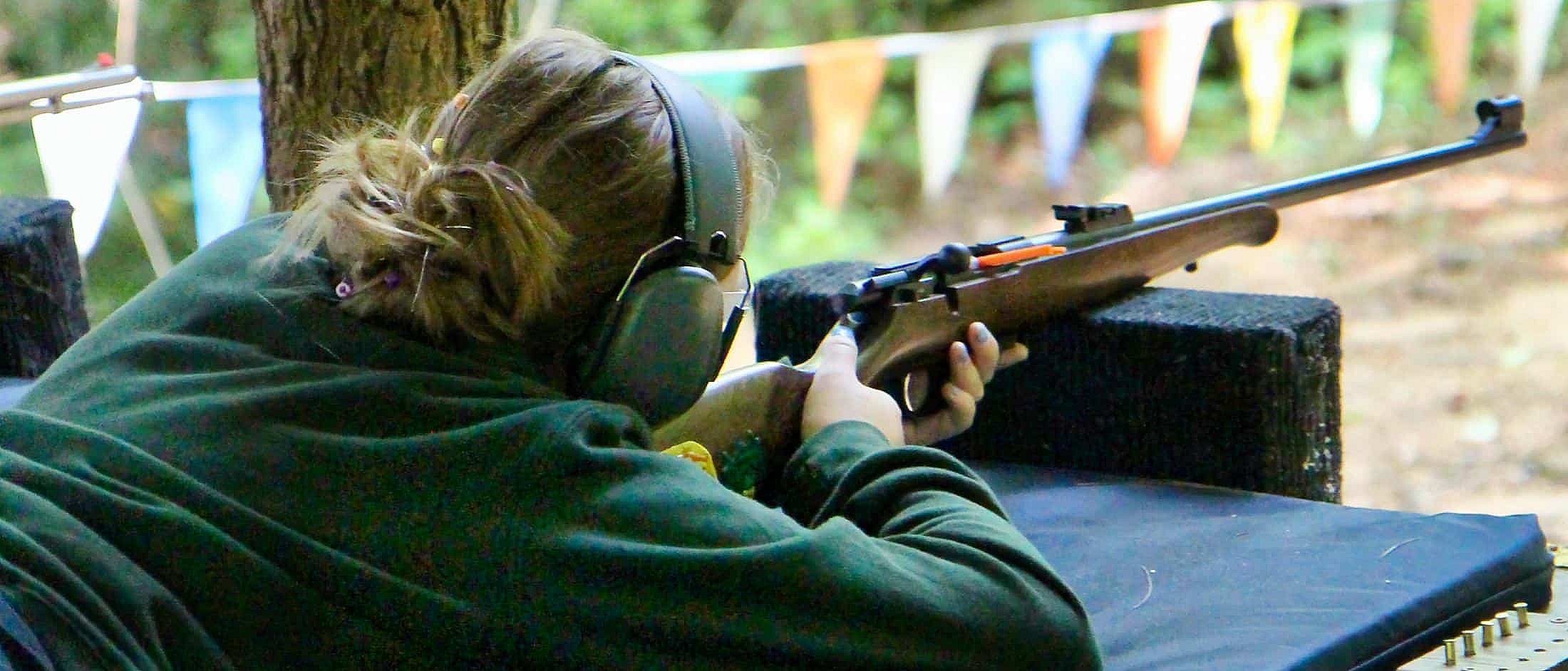woman aiming rifle