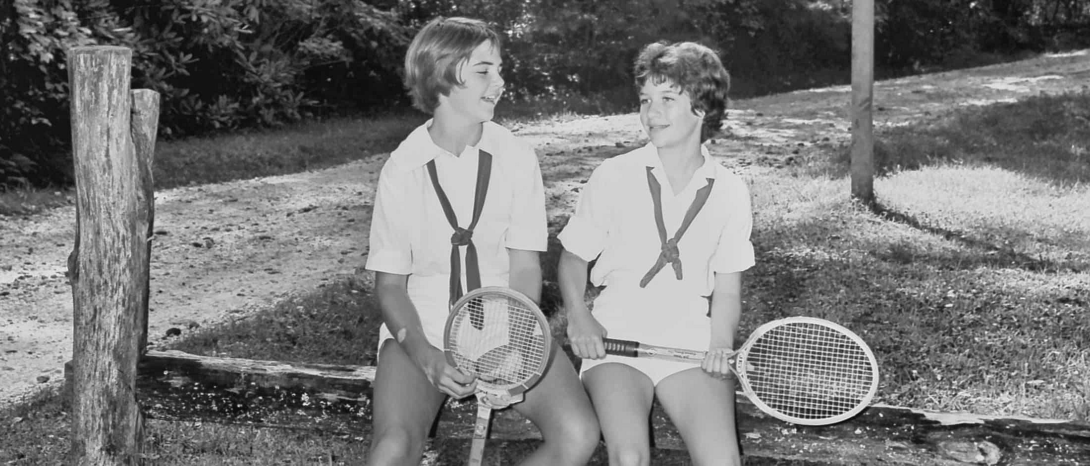 campers sitting with tennis racquets