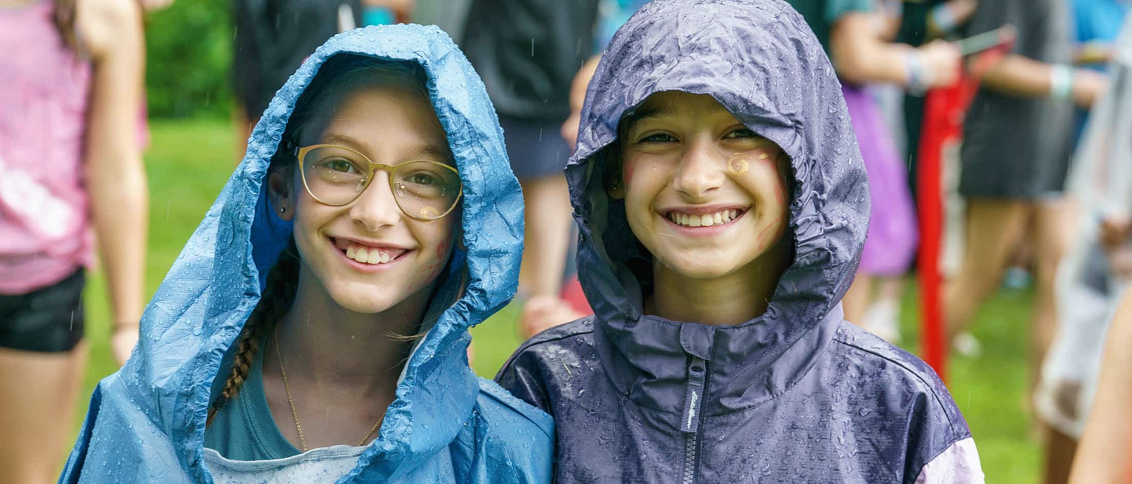 camp girls wearing raincoats