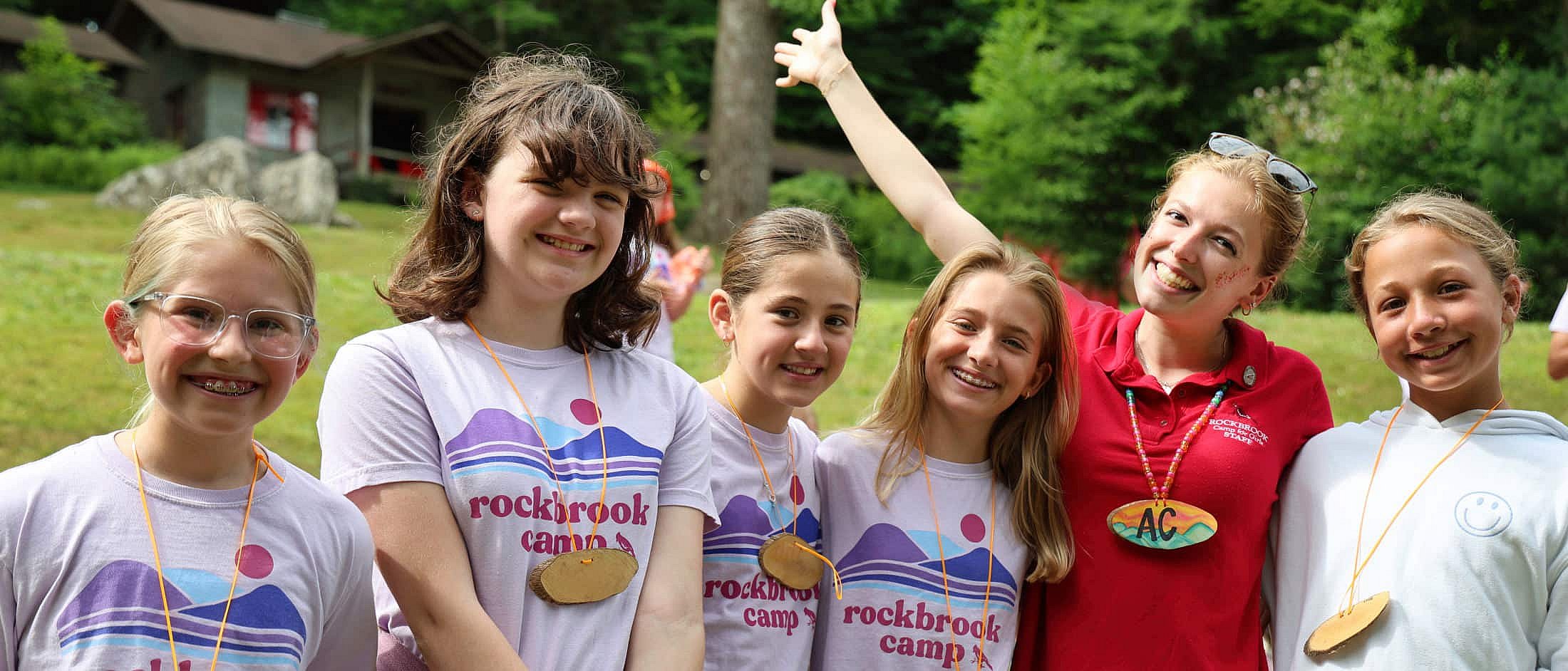 friends welcome girls to camp with cheers
