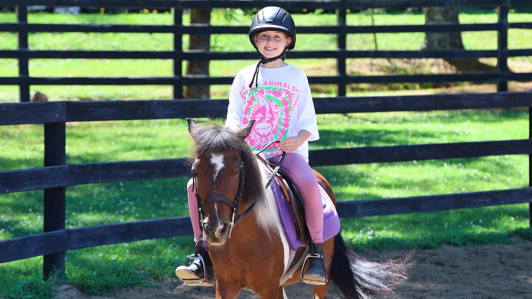 girl riding small welsh pony