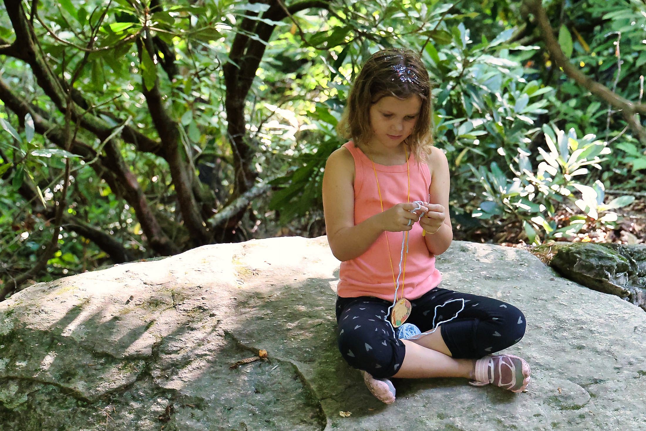mindful camp girl crochet on rock