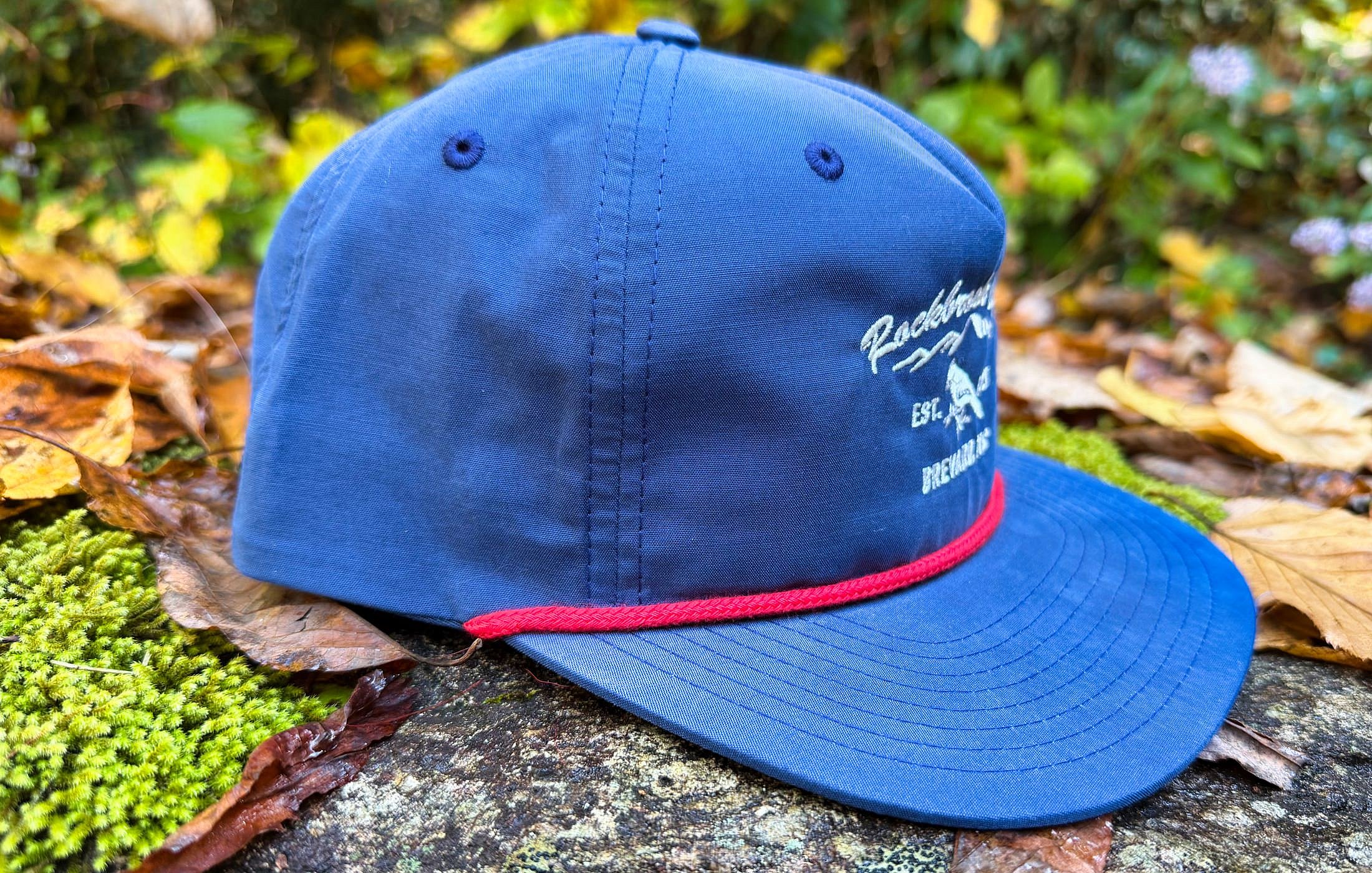 side view of navy and red cord flat-brim hat