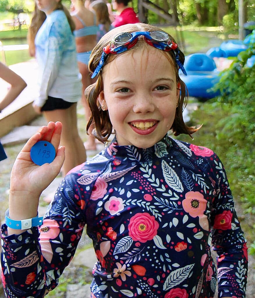 girls holding swimming tag