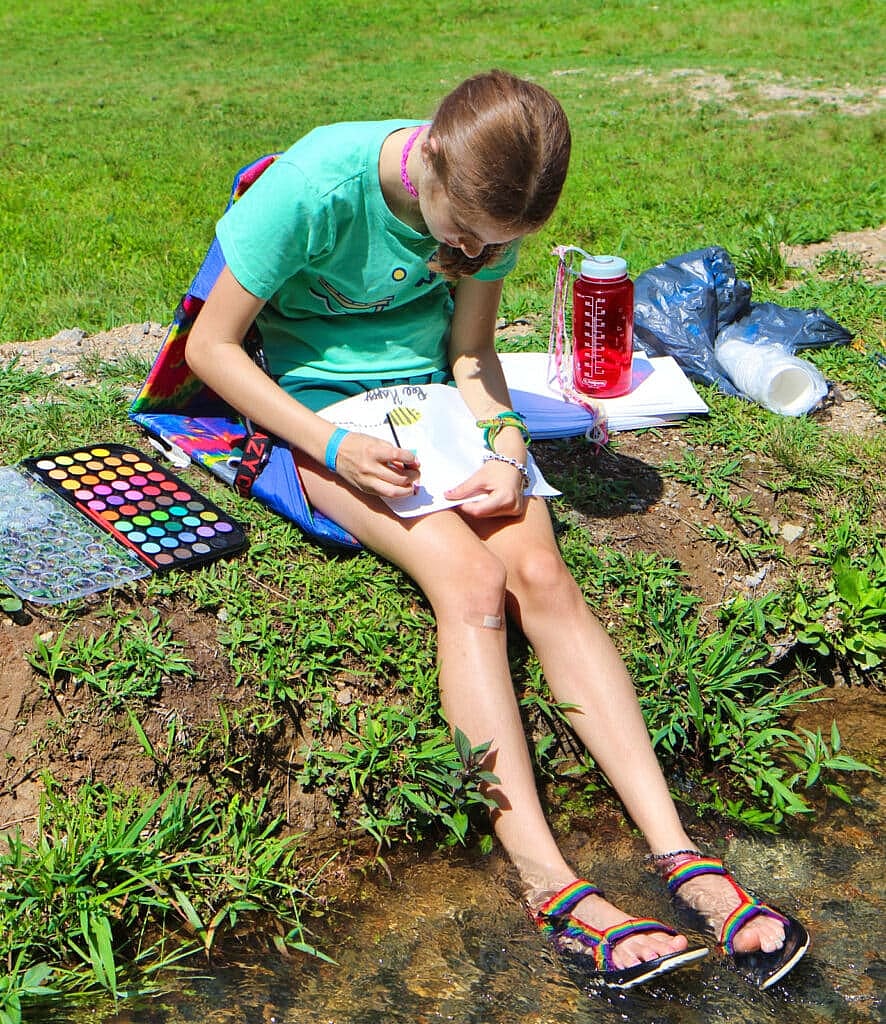 camp girl watercolor painting by the creek