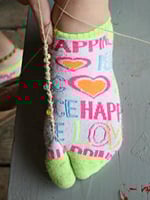 Friendship Bracelet Foot bracelet being tied to camper's toe