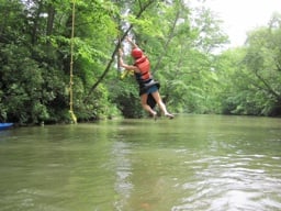 girl on camp rope swing