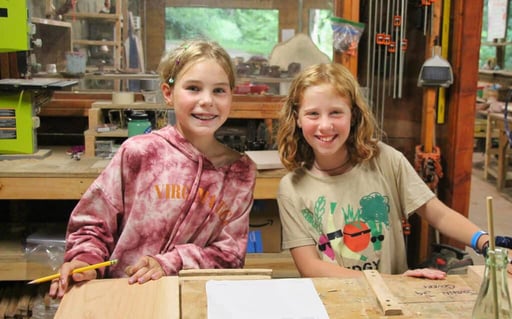 two camp kids in woodworking shop
