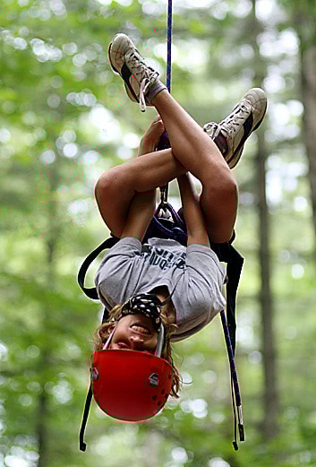 Kids learning to rock climb while at camp