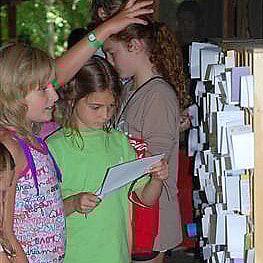 Girls receiving mail at summer camp