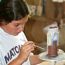 Camp girls painting ceramics pieces