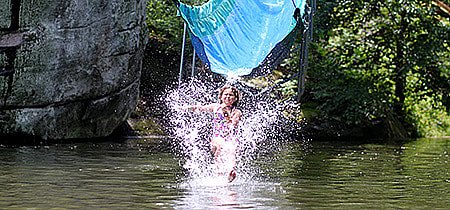 Camp Kid splashing down off the waterslide