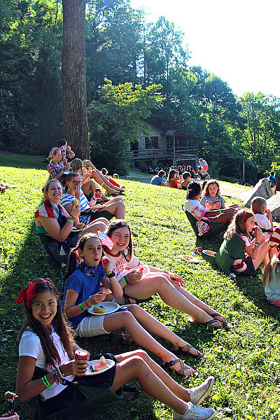 Eating cookout picnic on Hill at summer camp