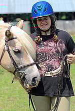 Girl camp camper posing with horse