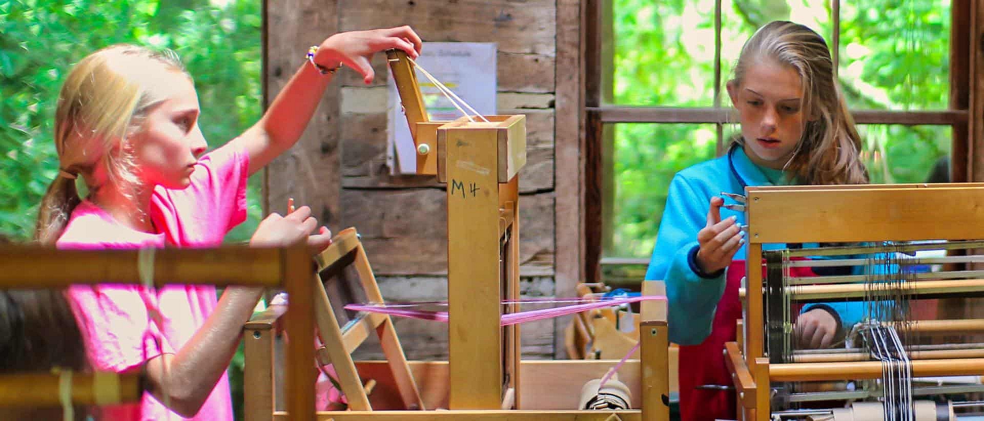 girls weaving at summer camp