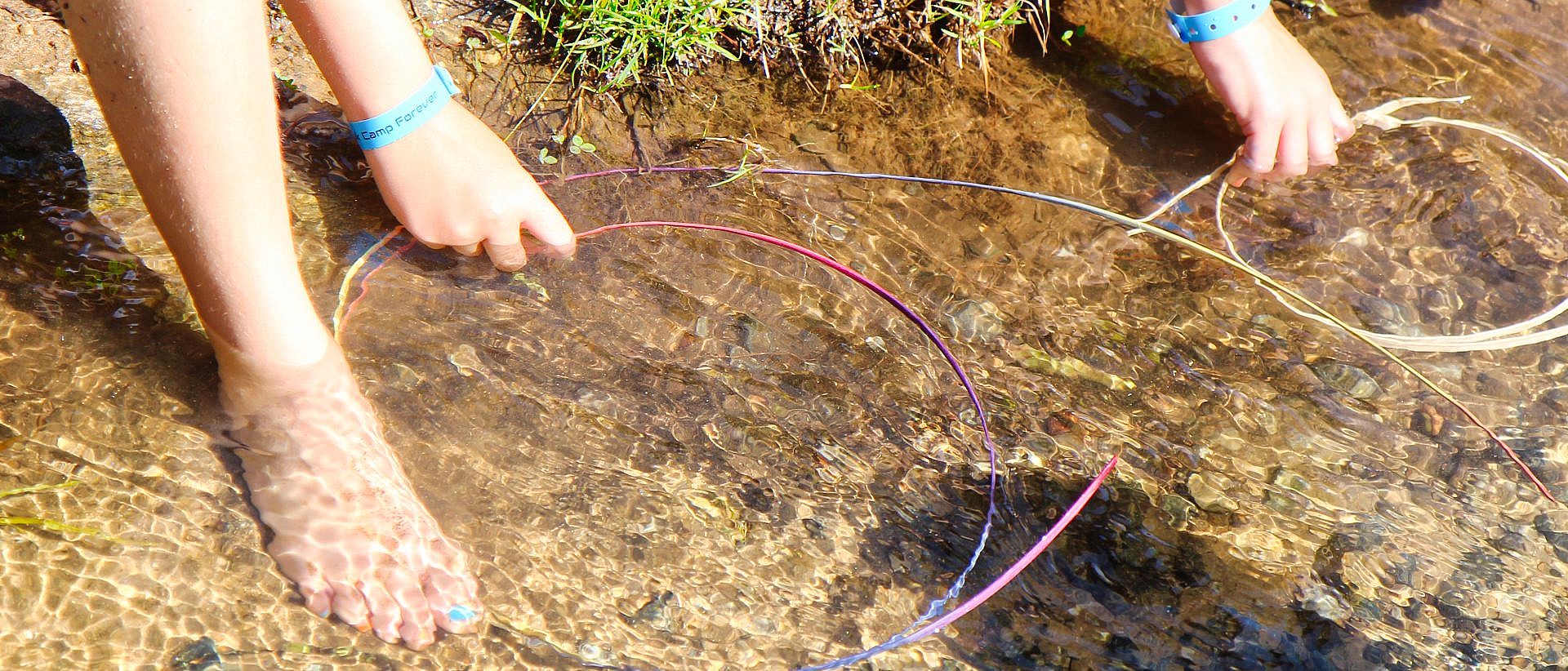 girls doing basketry with fee in creek