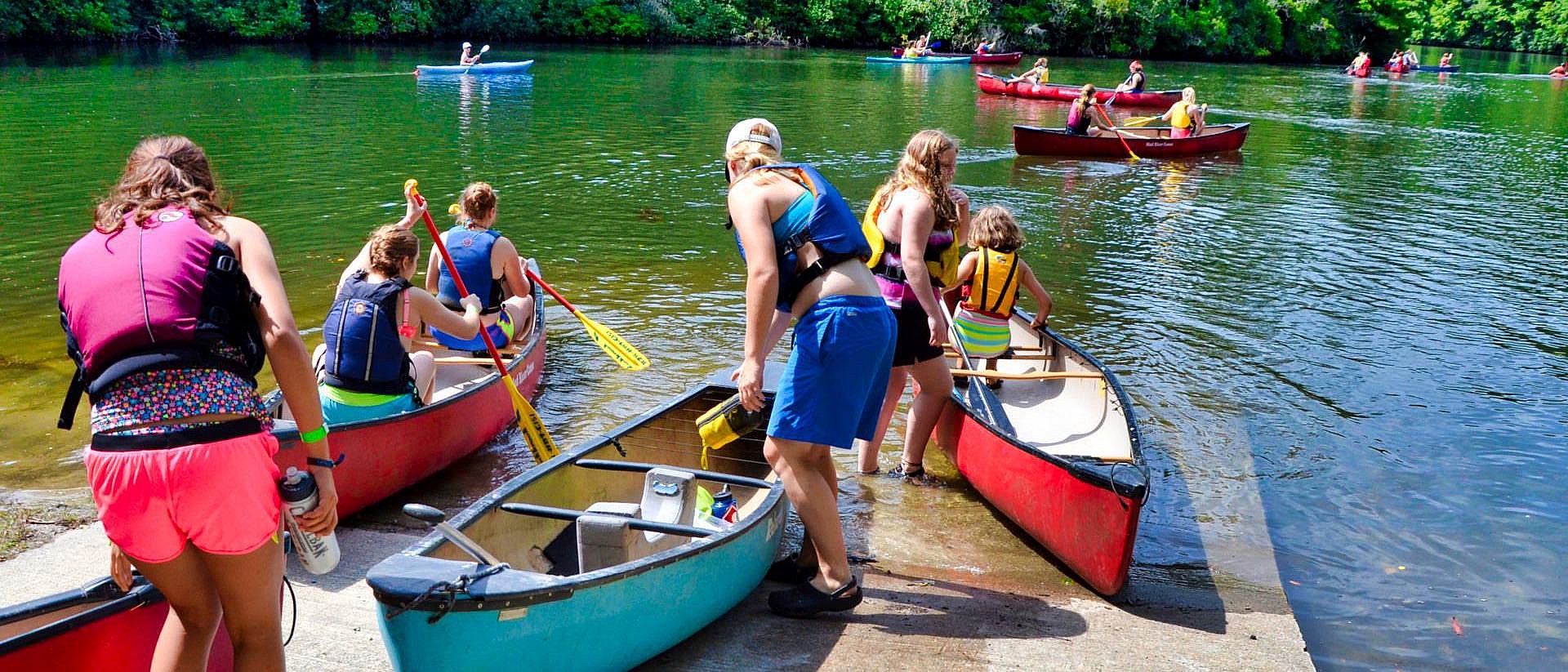 camper canoe launch into lake