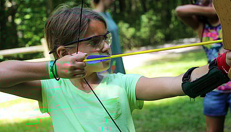 Junior camp girl shooting archery