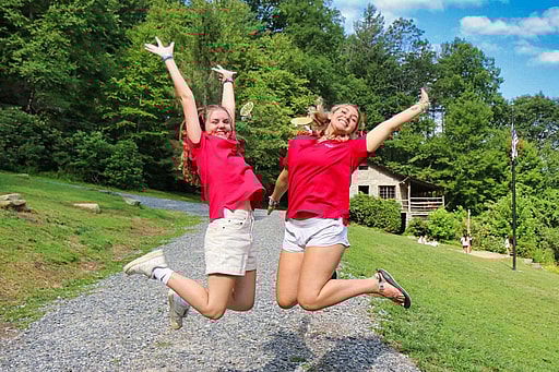 excited camp staff jumping