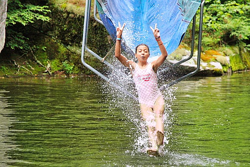 water slide peace sign kid