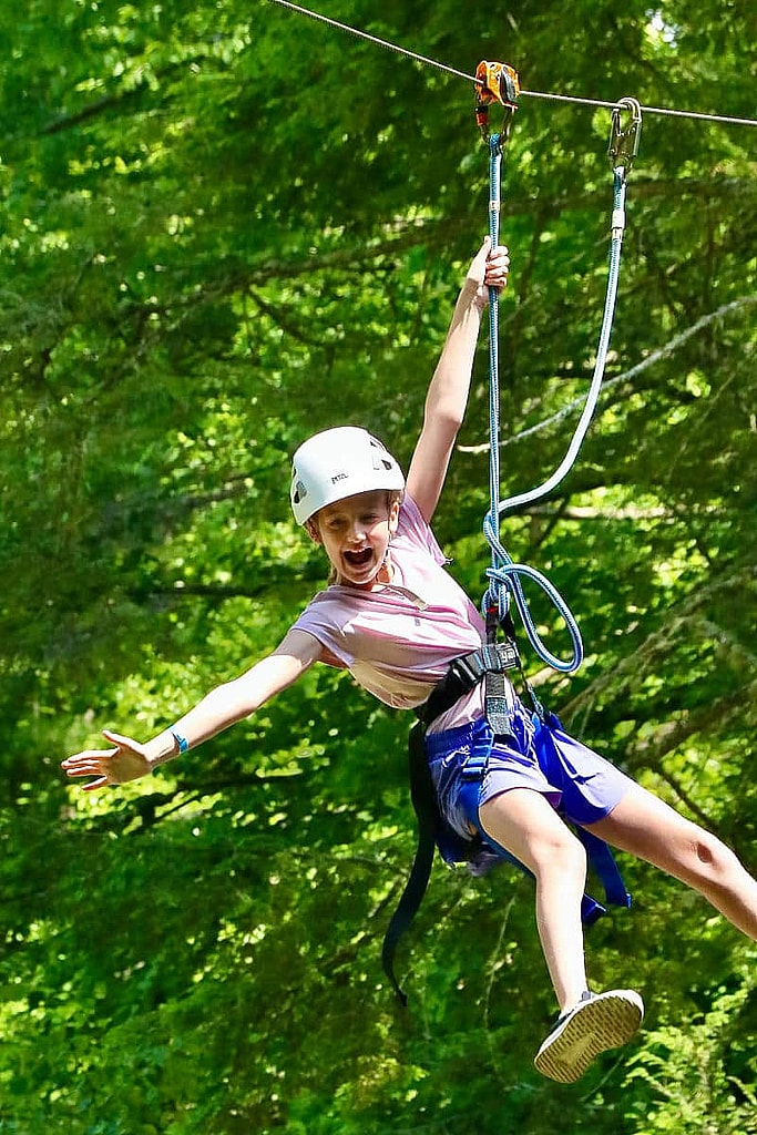 girl riding zip line