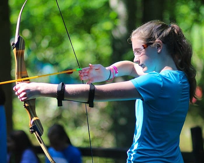 teenage girl shooting archery